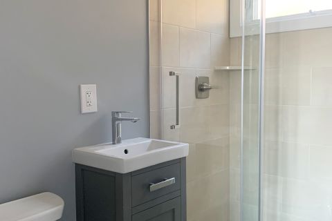 A White Sink Sitting Next To A Shower